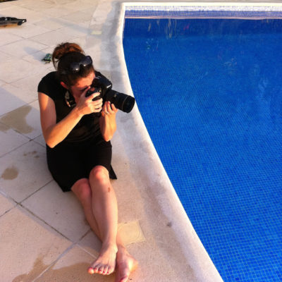 Katie Slater photographing wedding photos near a pool in costa rica